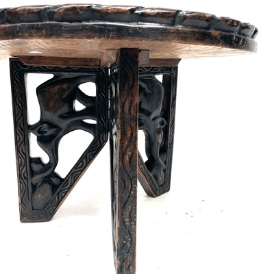 Lot 220 - An African wood carved circular folding table...