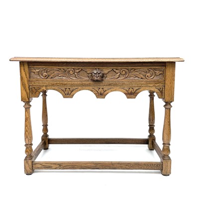 Lot 3089 - A 20th century oak side table carved in relief...