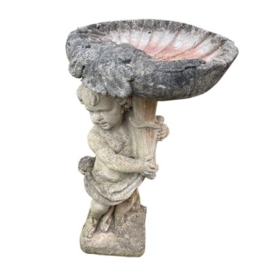 Lot 609 - A reconstituted stone figure of a cherub...