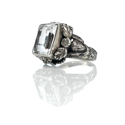 Lot 158 - An Arts & Crafts silver rock crystal set ring,...