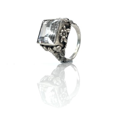 Lot 158 - An Arts & Crafts silver rock crystal set ring,...