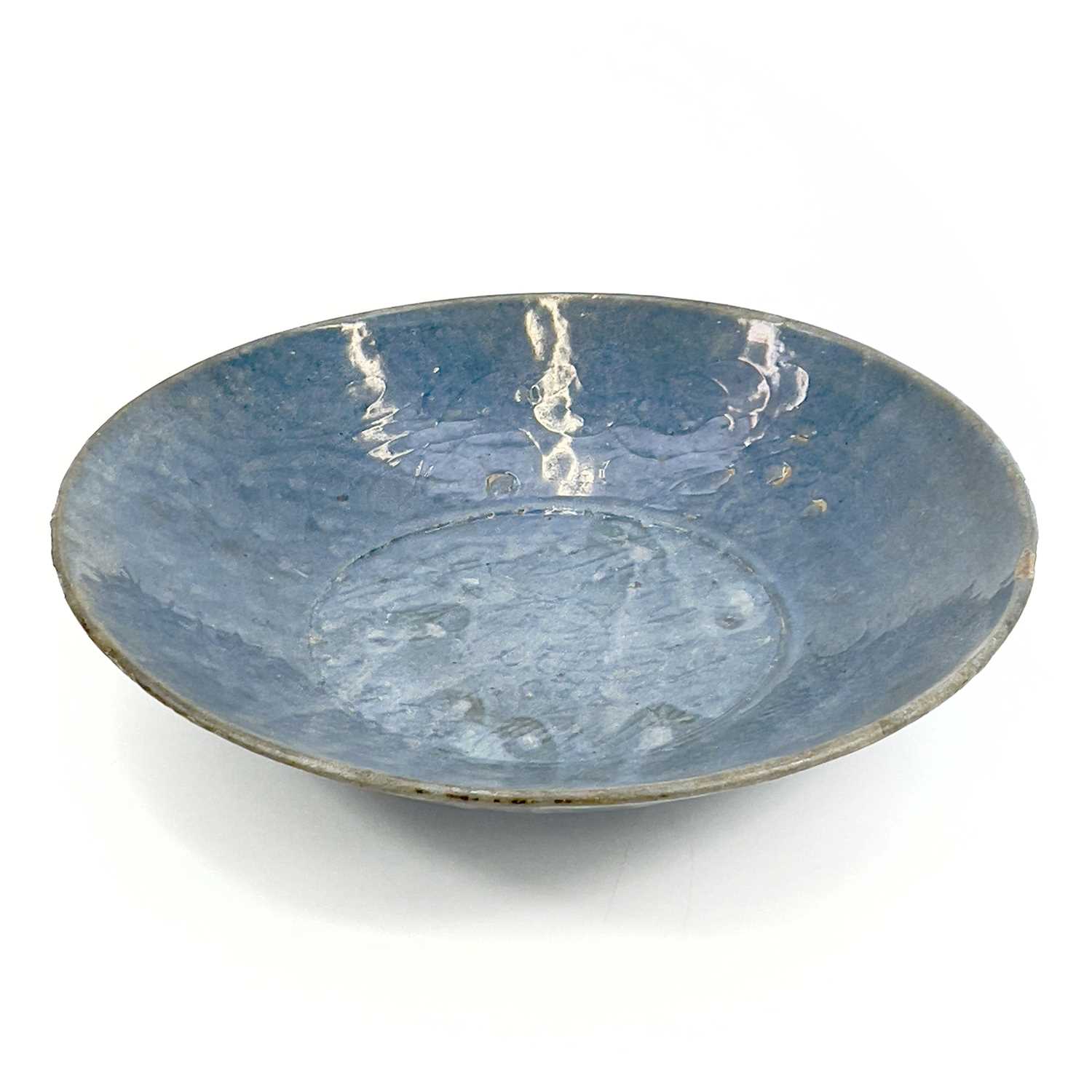 Lot 22 - A Chinese Swatow blue glazed dish, late Ming...