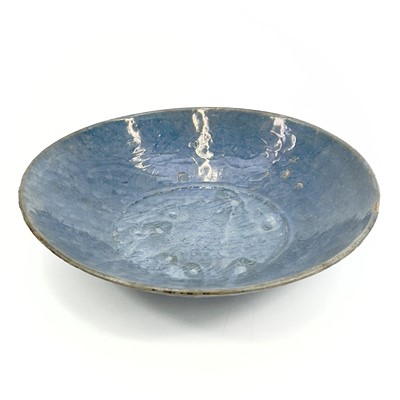 Lot 22 - A Chinese Swatow blue glazed dish, late Ming...