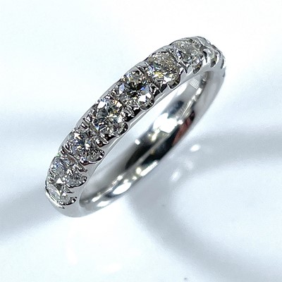 Lot 197 - A platinum diamond set half eternity ring, the...