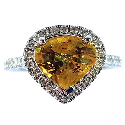 Lot 60 - An 18ct white gold yellow sapphire and diamond...
