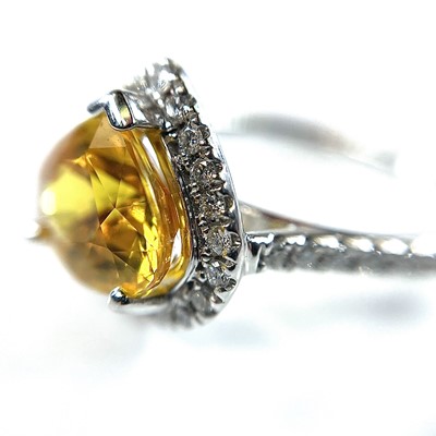 Lot 60 - An 18ct white gold yellow sapphire and diamond...