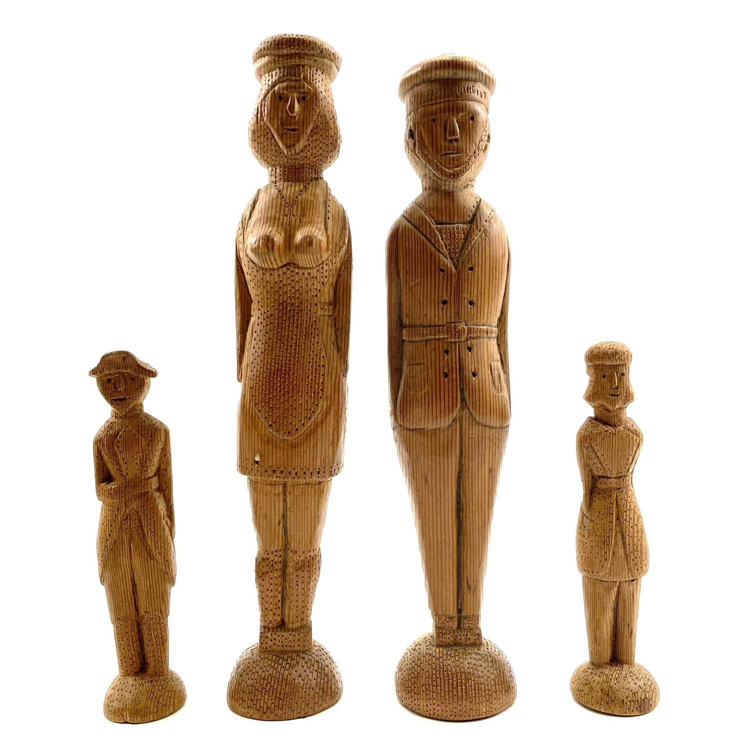 Lot 48 - A pair of pitch pine folk art peg figures of a French sailor and a lady.