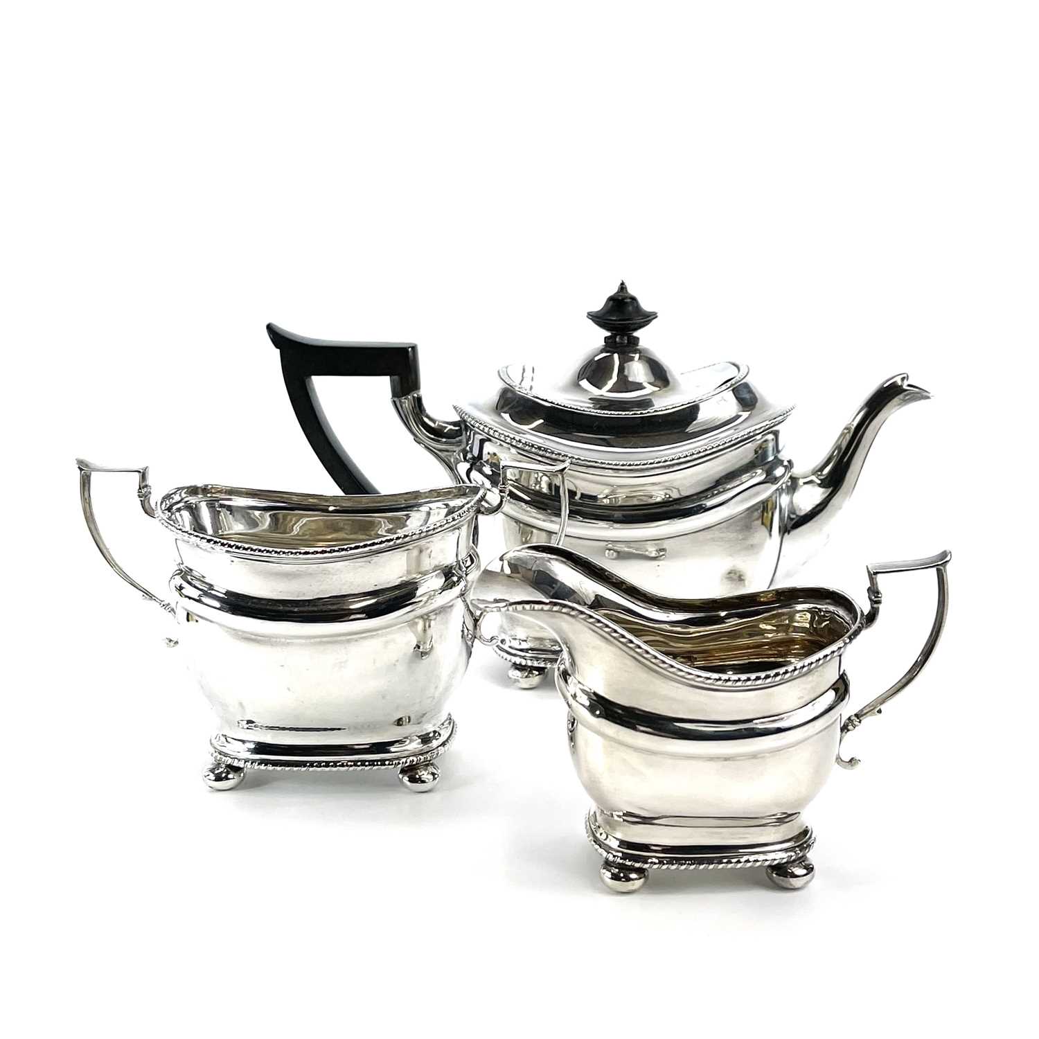Lot 8 - A George V silver three piece tea set by...
