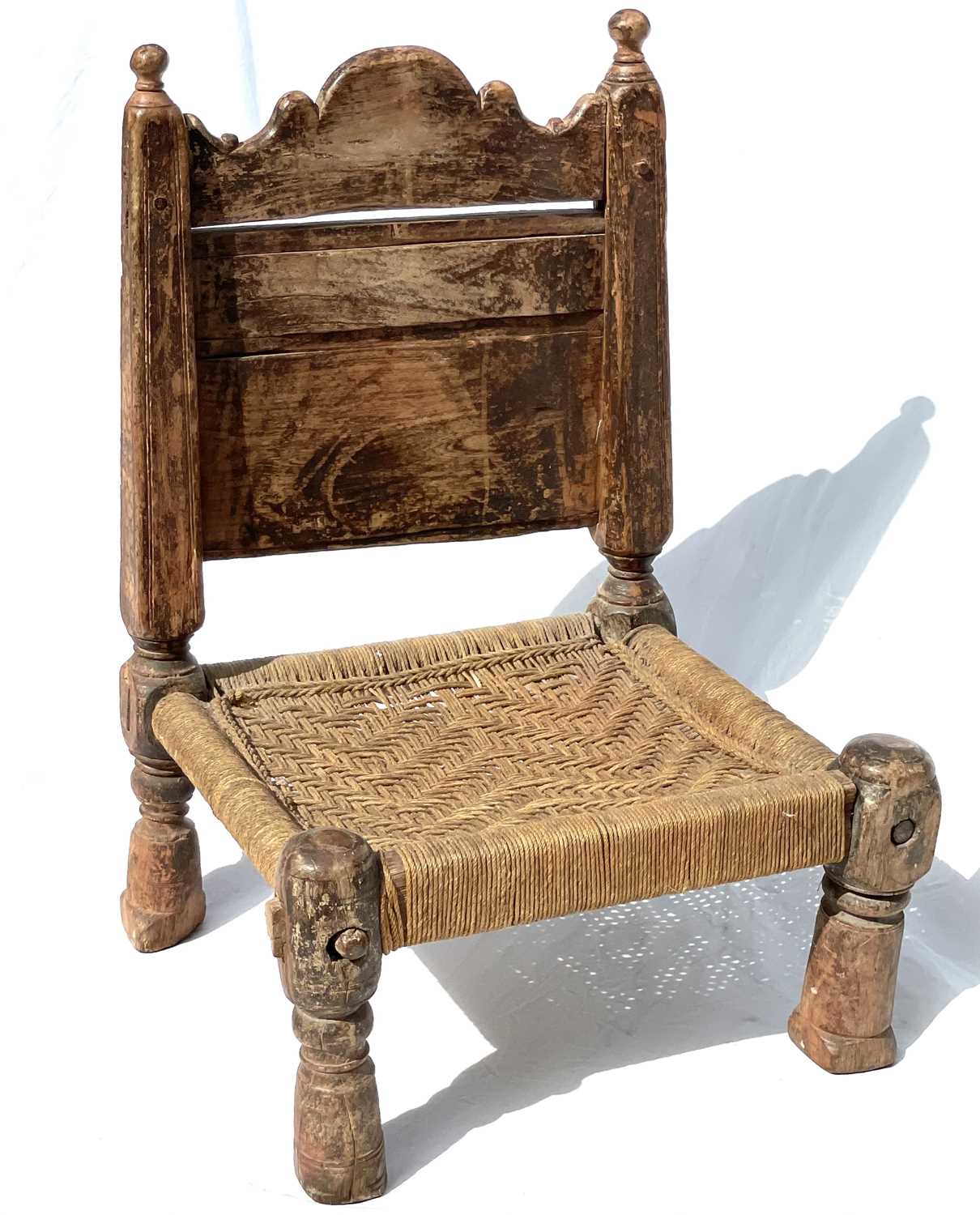 Lot 1016 - An Afghan carved wood low chair, 19th century,...