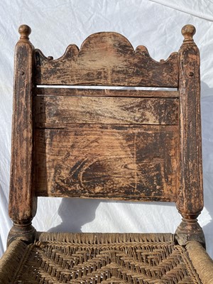 Lot 1016 - An Afghan carved wood low chair, 19th century,...