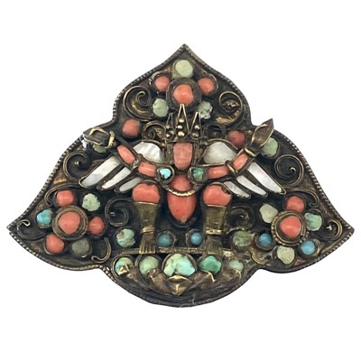 Lot 272 - A Tibetan gilt metal coral, mother of pearl and turquoise set buddha brooch.