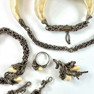 Lot 245 - A collection of stag's tooth white metal...
