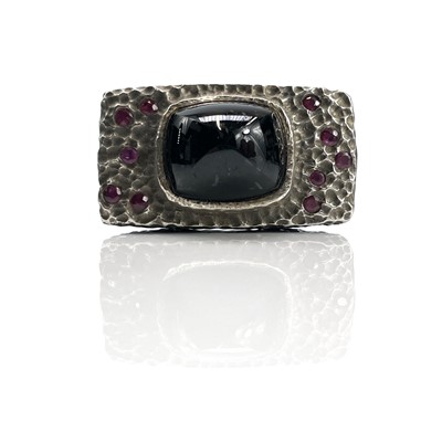 Lot 192 - A mid-century silver ruby and black stone set...
