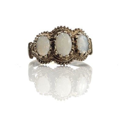 Lot 235 - A 9ct 1970's white opal three stone ring, size...