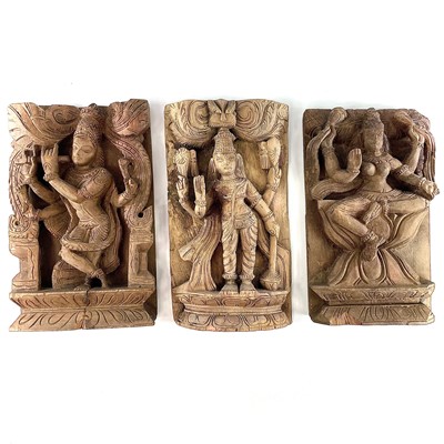 Lot 296 - Three carved wood panels of deities, early-mid...