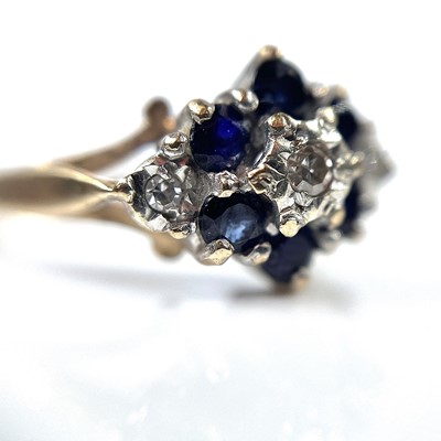 Lot 185 - A 9ct diamond and sapphire nine stone cluster...