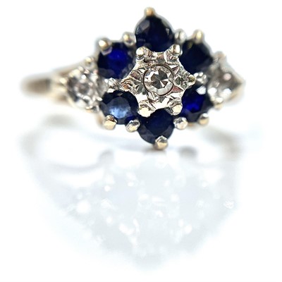 Lot 185 - A 9ct diamond and sapphire nine stone cluster...