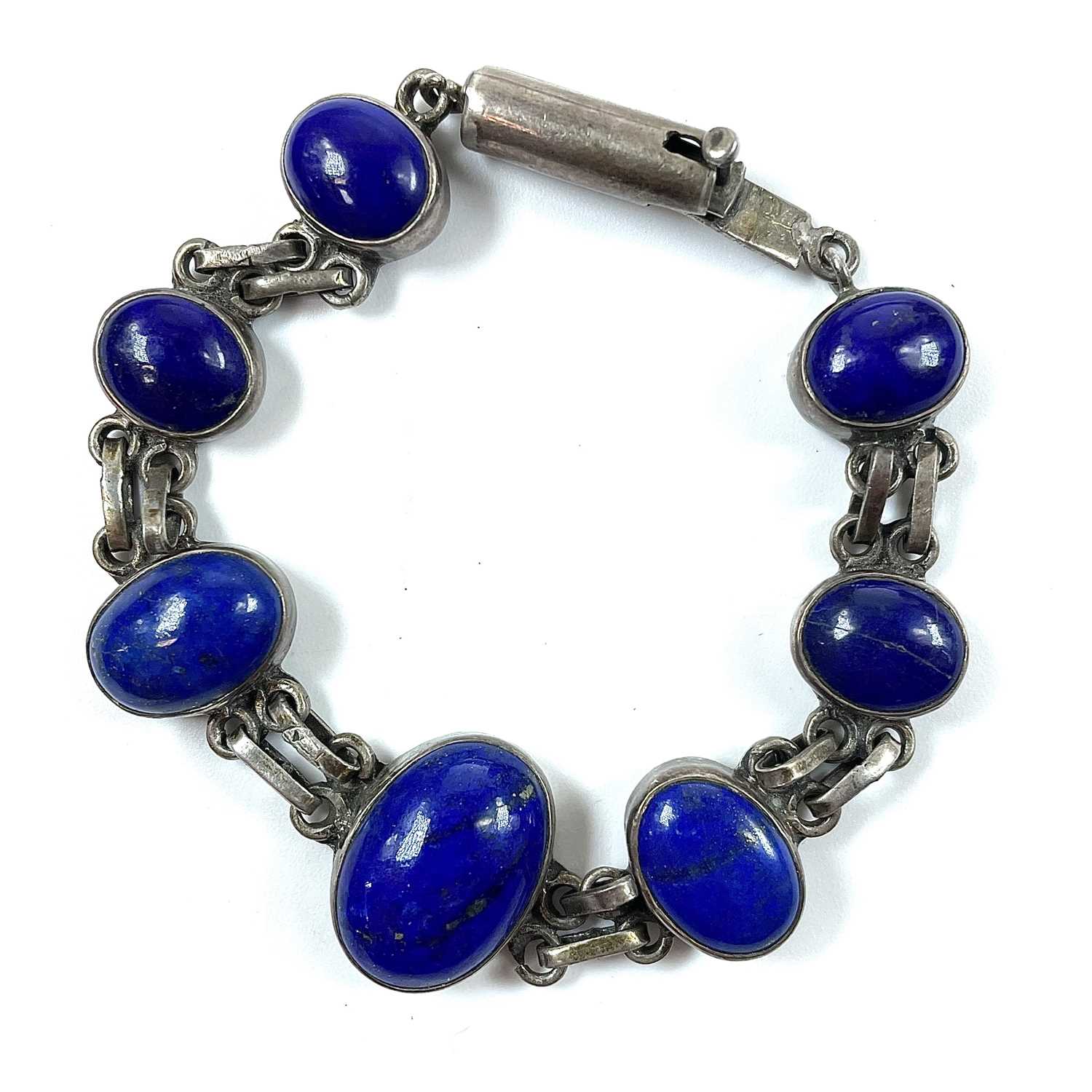 Lot 204 - A silver and lapis lazuli set bracelet, length...