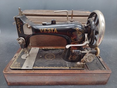 Lot 31 - A Vesta handcrank sewing machine and a wooden...