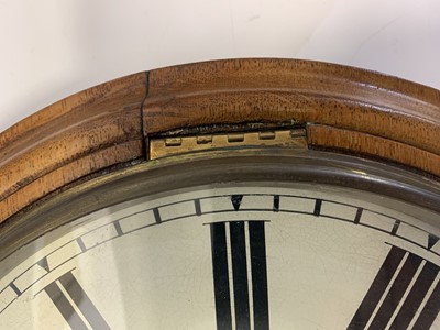 Lot 72 - A circular oak railway wall clock, late 19th century.