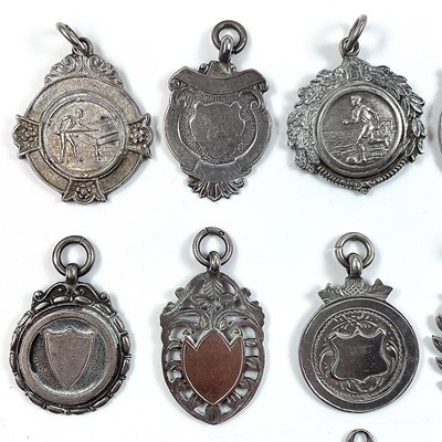 Lot 251 - A collection of thirteen silver shield fobs,...