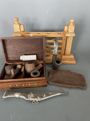 Lot 18 - A collection of pipe bowls, a pipe stand, and...
