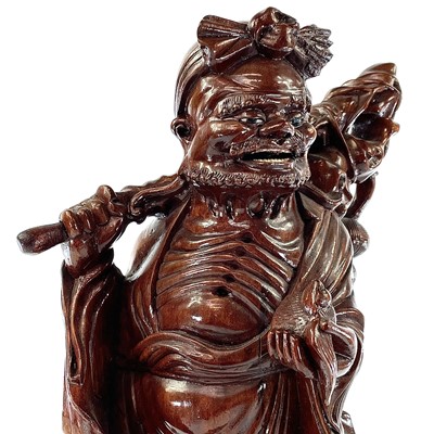 Lot 82 - A Chinese carved wood figure of a man carrying...