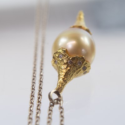 Lot 45 - A gold mounted diamond set South Sea pearl pendant