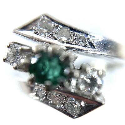 Lot 55 - A 14ct white gold damond and emerald crossover...