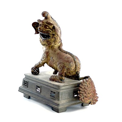 Lot 52 - A Chinese gilt metal model of a dog of fo,...