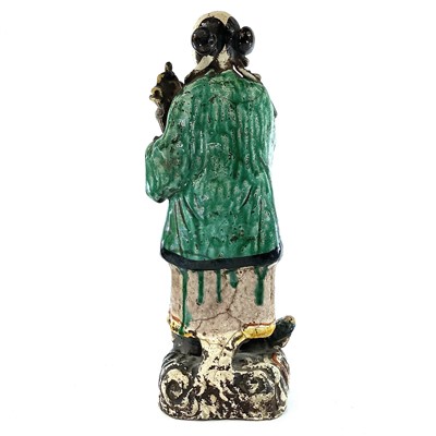 Lot 69 - A Chinese sancai-glazed standing figure,...