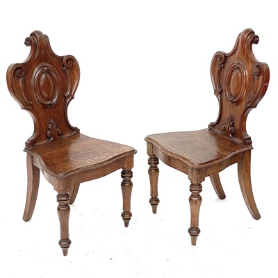 Lot 145 - A pair of late Victorian oak hall chairs.