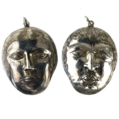 Lot 262 - A pair of modern silver mask pendants, maker Edmund Kaslewski.