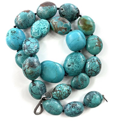 Lot 284 - A turquoise bead necklace with silver clasp,...