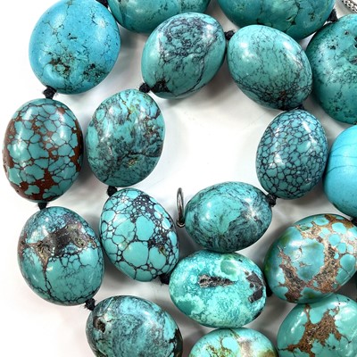 Lot 284 - A turquoise bead necklace with silver clasp,...