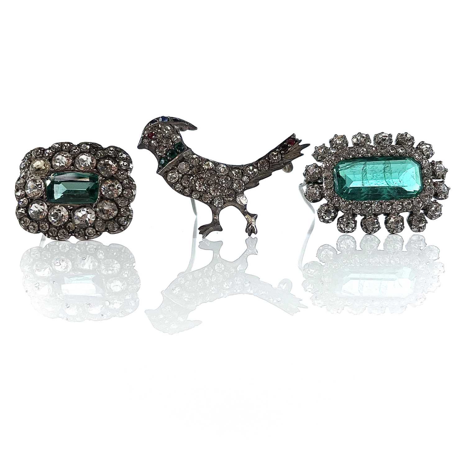 Lot 384 - Three white metal paste set brooches.