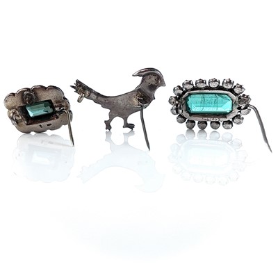 Lot 384 - Three white metal paste set brooches.