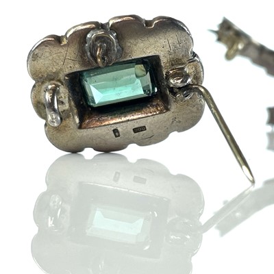 Lot 384 - Three white metal paste set brooches.