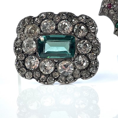 Lot 384 - Three white metal paste set brooches.