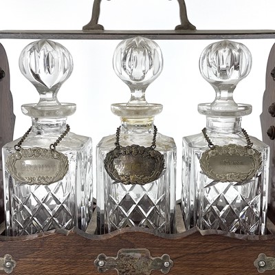 Lot 147 - An Edwardian oak and silver plated three...