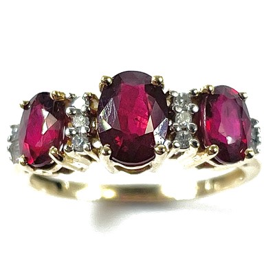 Lot 53 - A 14ct ruby and diamond ring, the central oval...