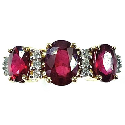 Lot 53 - A 14ct ruby and diamond ring, the central oval...