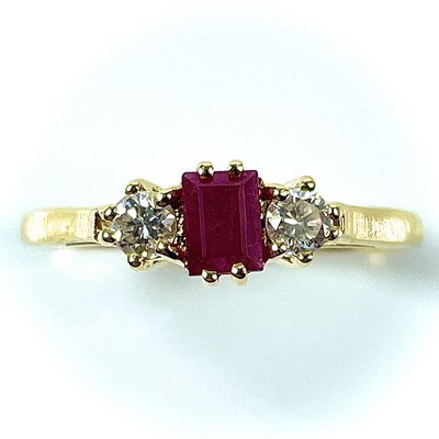 Lot 125 - An 18ct gold ruby and diamond three stone ring,...