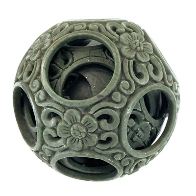 Lot 168 - Two Chinese green hardstone puzzle balls,...