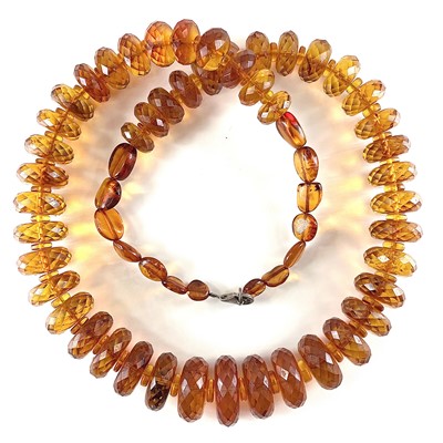 Lot 233 - A faceted honey amber necklace, 71 grams, full...