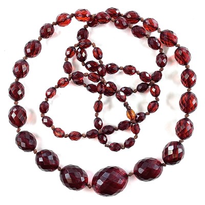 Lot 261 - A cherry 'amber' bakelite graduated bead...