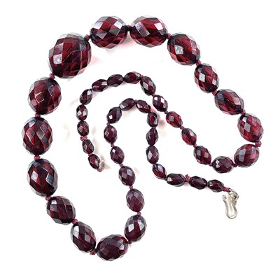 Lot 262 - A cherry 'amber' bakelite graduated bead...