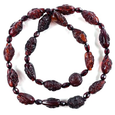 Lot 257 - A Chinese cherry 'amber' bakelite bead...