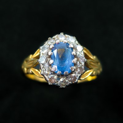 Lot 142 - An early 20th century 18ct (tested) yellow and white gold sapphire and diamond cluster ring.