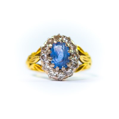 Lot 142 - An early 20th century 18ct (tested) yellow and white gold sapphire and diamond cluster ring.